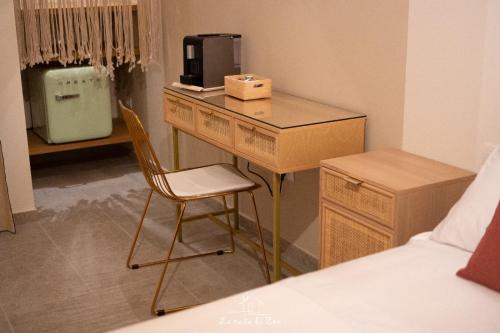 a desk in a bedroom with a bed and a chair at LA CASA DI ZOE in Manfredonia