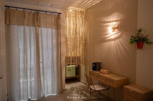 a room with a desk and a window with curtains at LA CASA DI ZOE in Manfredonia