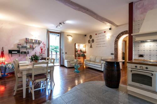 a kitchen and living room with a table and a couch at Residence Azalea&glicine by Halldis in Griante Cadenabbia