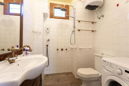 a bathroom with a sink and a toilet and a shower at Residence Azalea&glicine by Halldis in Griante Cadenabbia