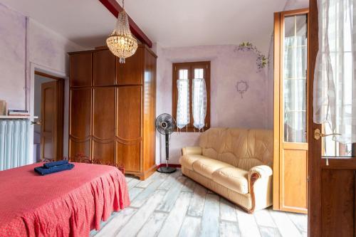 a living room with a couch and a fan at Residence Azalea&glicine by Halldis in Griante Cadenabbia