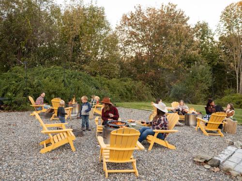 a group of people sitting in chairs in a park at Seascape Motel & Cottages in Belfast