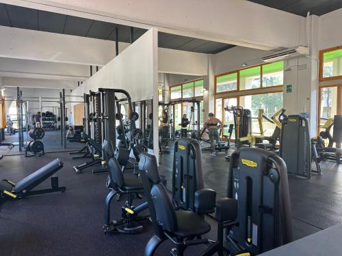 a gym with a bunch of treadmills and machines at Villa Riviera by the Sea in Lignano Sabbiadoro