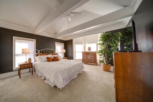 a bedroom with a bed and a dresser and windows at Peninsula Paradise - Walk to Hiking and Shopping! in Peninsula