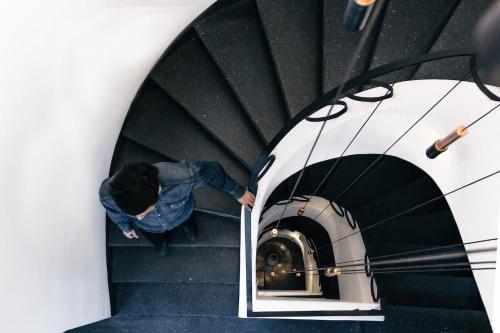 a person walking down a spiral staircase at Casa Decu in Mexico City