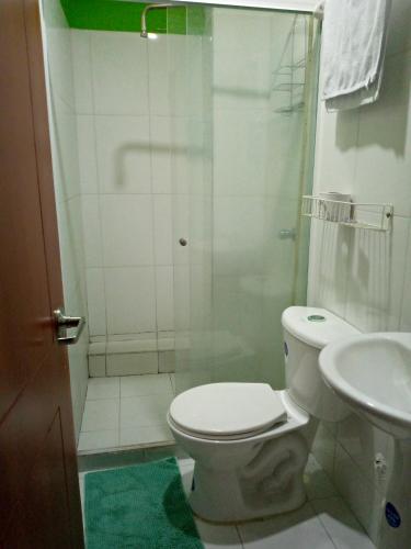 a bathroom with a shower and a toilet and a sink at Hotel La Isla in San Gil