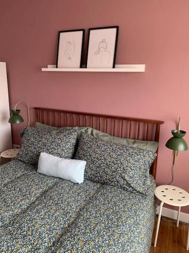 a bedroom with a bed with two pictures on the wall at Tenby 2 bed flat with parking, plus pet in Tenby