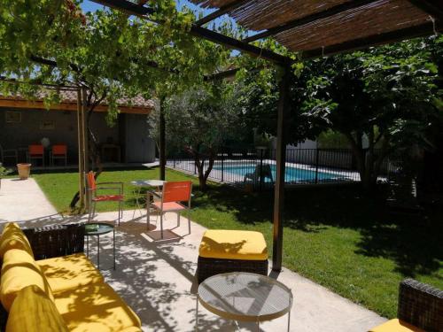 un patio avec une table et des chaises et une piscine dans l'établissement Beautiful vacation rental with private pool in the heart of the city of Avignon, sleeps 8., à Avignon