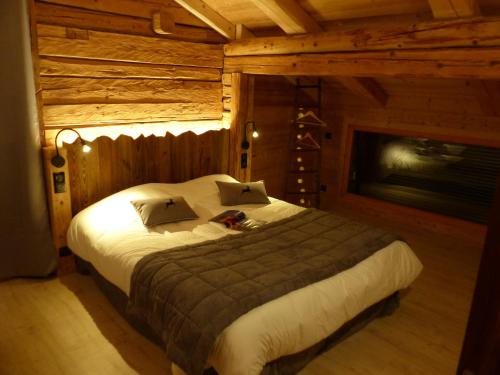 a bedroom with a large bed in a wooden room at Appartement Le Grand-Bornand, 4 pièces, 10 personnes - FR-1-467-100 in Le Grand-Bornand