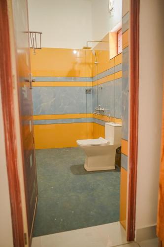 a bathroom with a toilet and a sink at Shimano Square in Varkala