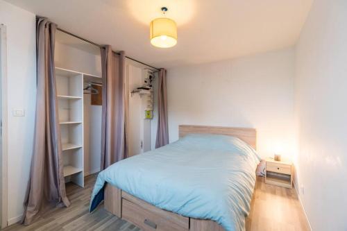 um pequeno quarto com uma cama e um closet em Maison familiale à Trégastel - proche des plages em Trégastel