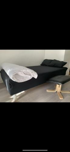 a bed with black sheets and pillows in a bedroom at Oslo new center in Oslo