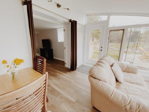 a living room with a couch and a table at Irish Mountain Suites in Meaford
