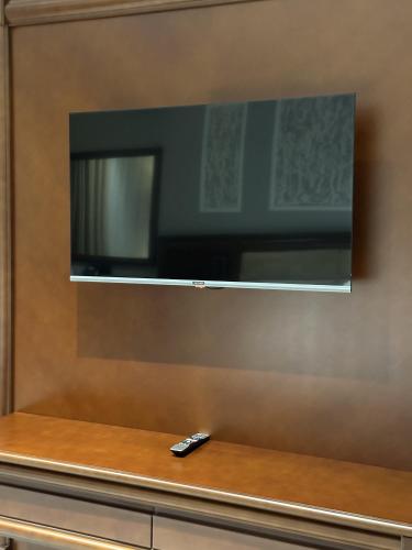 a remote control sitting on a counter with a television at Mir Luxe Plaza in Tashkent