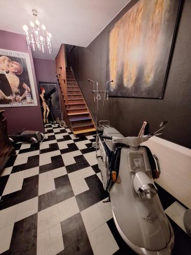 a bathroom with a toilet sitting on a checkered floor at Le Dépôt in Spa