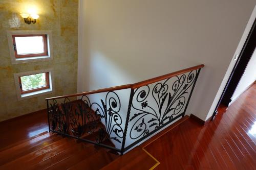 a staircase with a wrought iron railing in a room at RADOVICI LUX APARTMENTS in Radovići