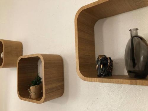 a vase on a shelf next to a vasephasis at ღ Le Cypriano • T2 au Centre de Valence AVEC PARKING in Valence
