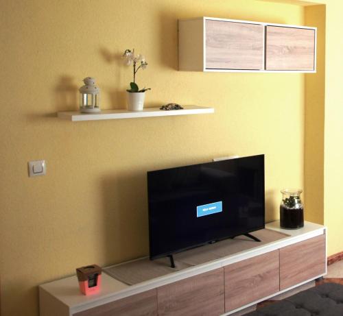 a living room with a flat screen tv on a wall at Piso acogedor a 50m de la playa in Almería