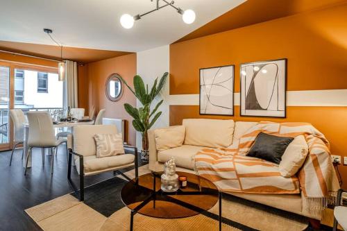a living room with a couch and a table at Exquisite Living with BicoccaStays in Aberdeen