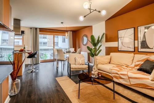 a living room with a couch and a table at Exquisite Living with BicoccaStays in Aberdeen
