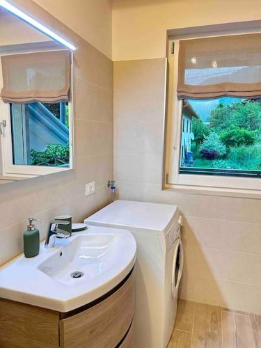 a bathroom with a white sink and a window at Agordo Col di Foglia in Agordo