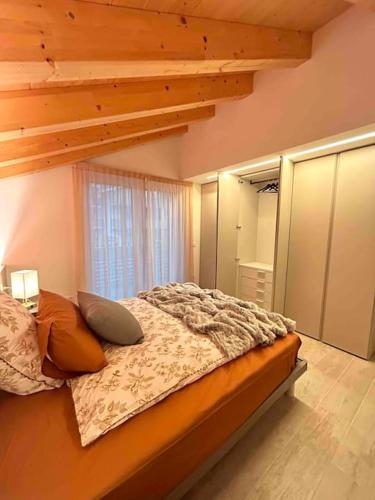 a bedroom with a bed with pillows and a ladder at Agordo Col di Foglia in Agordo