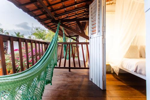 a hammock on the balcony of a house at Vila Charme in Jericoacoara