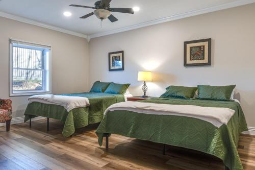two beds in a room with a ceiling fan at Enchanting Montgomery Escape with Private Hot Tub! in Washington