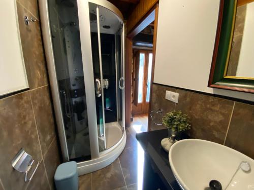 a bathroom with a sink and a shower at El Portalón de Luena - Casa Rural in Tablado