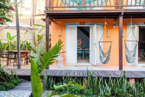 a house with an open door and a patio at Vila Charme in Jericoacoara