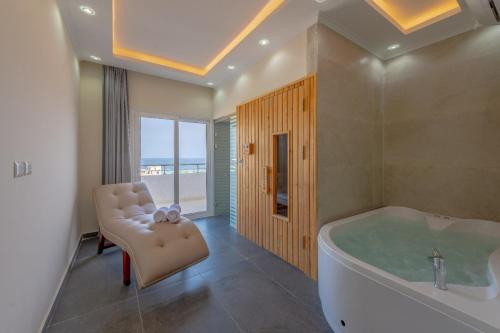 a large bathroom with a tub and a chair at unique villa with heated pool and Spa in Hurghada
