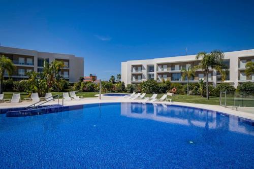 a large swimming pool in front of a building at GINVA - Costa Ballena & Eleven Views in Costa Ballena