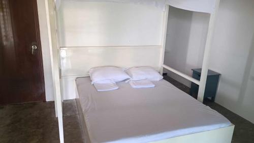 a white bunk bed with two white pillows on it at SCIA Hills Exclusive 25pax WiFi Netflix HBO Videoke Pool in Oslob