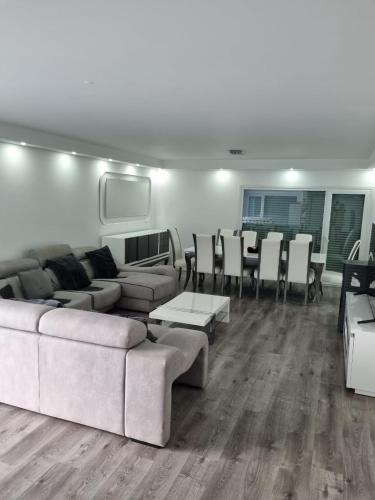 a living room with a couch and a table and chairs at Mikaela Guest House 2 in Ramada