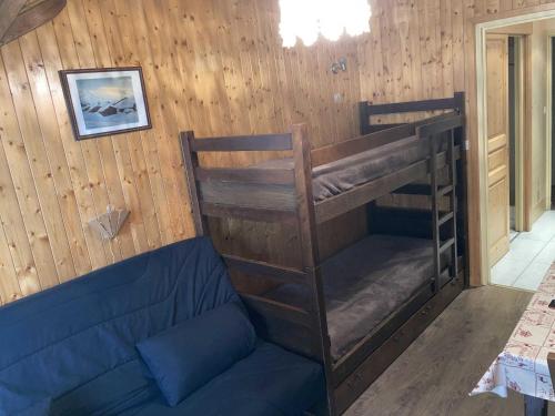 a room with a bunk bed and a couch at Studio Le Grand-Bornand, 1 pièce, 3 personnes - FR-1-467-116 in Le Grand-Bornand