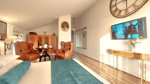 a living room with a large clock on the wall at Refresh Boutique Apartments in Vodice