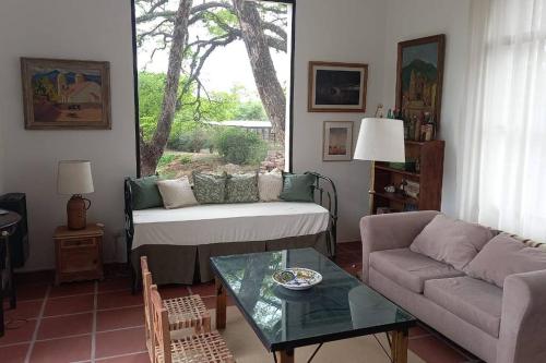 a living room with a couch and a table at La Justina - Casa de Campo en San Lorenzo in San Lorenzo