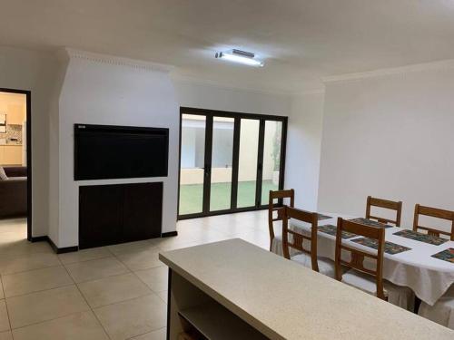 a dining room with a table and some chairs at Fairways Villa @ Bunker Close in Walvis Bay