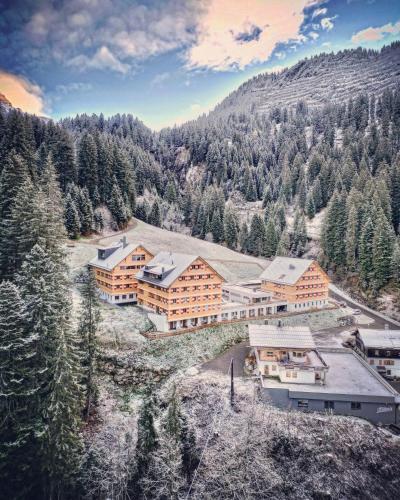 an aerial view of a resort in the mountains at Berghaus Schröcken - Hotel Apartments Spa in Schröcken