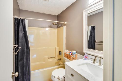 a bathroom with a sink and a toilet and a mirror at Ski-In and Out and Golf Condo with A and C at Holiday Valley! in Ellicottville