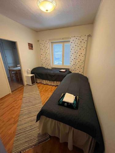 a bedroom with a bed and a window at Majoitusta 4:lle Pori in Pori