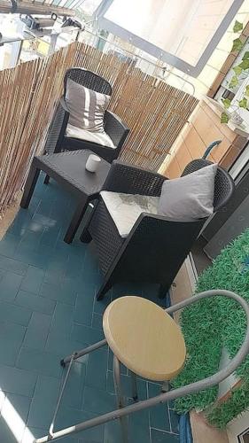 an overhead view of a balcony with chairs and a table at House Arrow in Latina
