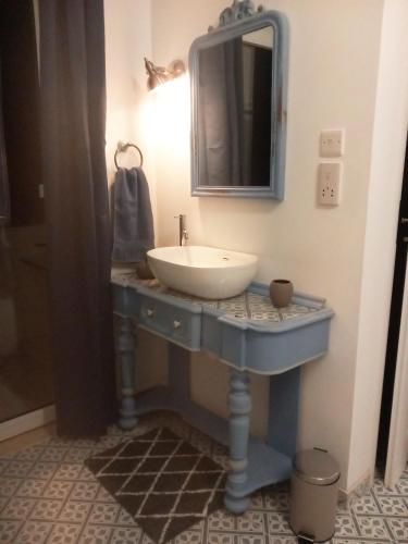 a bathroom with a sink and a mirror at Door Nine -Townhouse with harbour views in Il-Furjana