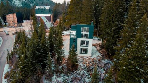 an aerial view of a building in the middle of trees at Kuca 59 in Jahorina