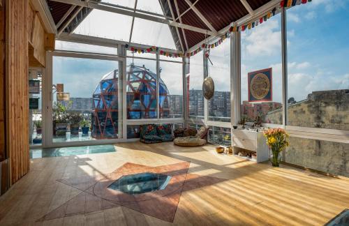 a large room with a view of a city at Mandala Yoga Hostel in Bogotá