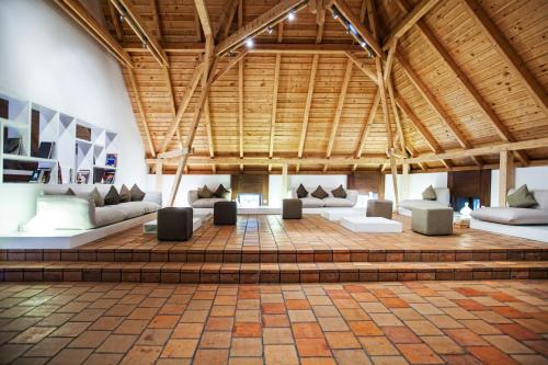 a large room with couches and tables in a building at Sopron Monastery Hotel in Sopron