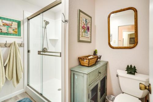 a bathroom with a shower and a toilet and a mirror at Cozy Condo with Fireplace - Near Brian Head Resort! in Brian Head