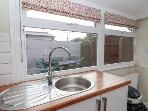 a kitchen with a sink and a window at Sea View House in Hornsea