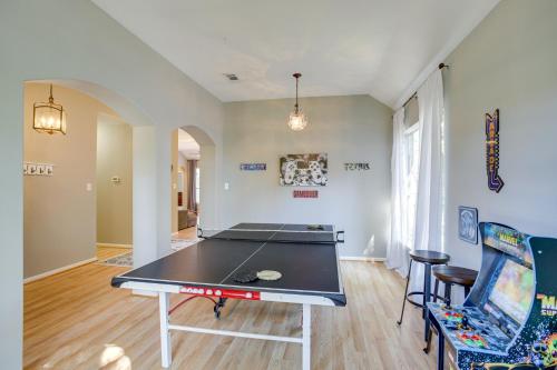 a living room with a ping pong table in it at Humble Home with Game Room, Near Deerbrook Mall! in Humble