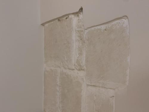 a corner of a brick wall in a room at Ritucci Suite in Lecce